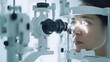 © pjjaruwan - A patient getting an eye examination with advanced optical equipment in a bright, modern clinic