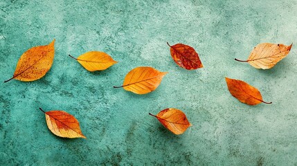 Poster -   A cluster of orange foliage resting on a blue backdrop beside a green background, with additional orange leaves scattered on top