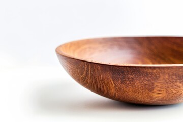 Poster - A simple wooden bowl sits on a table with a rustic or vintage feel