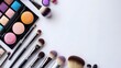 © Apiwat - Vibrant makeup brushes and palettes, arranged on a clean white background