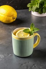 Warm cup of herbal tea garnished with fresh mint leaves.