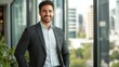 © Bijac - confident businessman in crisp attire standing in a modern glasswalled office relaxed pose and warm smile conveying success and approachability with city skyline visible in the background