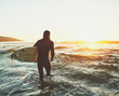 © StarDweller/peopleimages.com - Walking, surfer and man with surfboard at beach for water sport, adventure and tropical vacation. Back, tourist and person for surfing at ocean with fitness, mockup and activity for hobby and sunset
