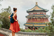 © Maridav - China Travel. Woman traveler relaxing enjoying travelling looking at nature view from old Chinese temple, tourist attraction in Beijing, china. Summer palace tourism destination, Asia travel