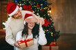 © Prostock-studio - Loving young handsome man giving surprise gift to his wife, closing her eyes, celebrating Christmas at home