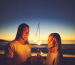 © StarDweller/peopleimages.com - Couple, travel and sparkler on beach at night for new year celebration, party event and together on holiday. Mockup space, people and fireworks at ocean sunset for vacation, happy and love at seaside