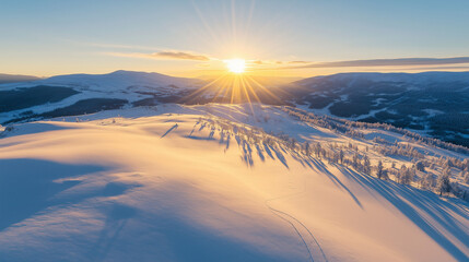 Wall Mural - a bright winter sunrise over a vast snowy mountain range, casting long shadows across the white expa