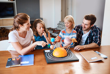 Wall Mural - Parents, children and science project for learning in home, building solar system and creativity. Family, support and kindergarten assignment on table, education and teaching knowledge on planets