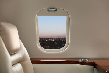 Canvas Print - Airplane taking off or landing, view on city from window