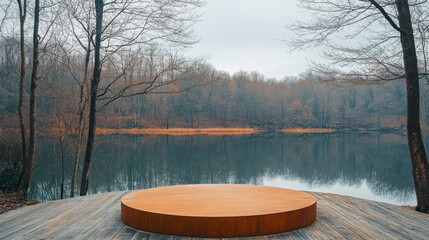 Poster - Early morning light casts a soft glow on a circular wooden platform by a serene lake, with bare trees reflecting on the still water's surface, highlighting the peaceful autumn landscape.
