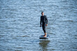 © homydesign - Silhouetted man on a hydrofoil surfboard