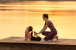 © Blue Jean Images - Mom And Daughter Doing Yoga In A Park