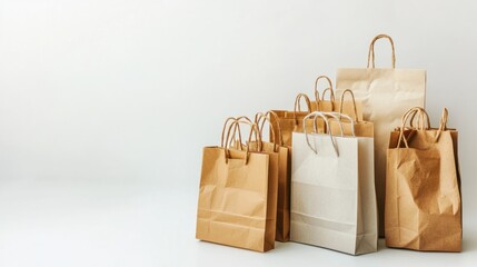 A set of recycled paper shopping bags in natural tones, arranged on a white backdrop