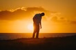 © senyumanmu - Silhouette of Man Standing in Sunset on Beach