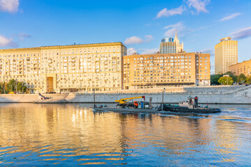 Wall Mural - A barge with a tugboat floats along the Moscow River