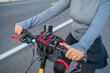 © Odua Images - woman hand holding bike handle bar, cropped photo
