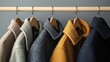 © Thanyaporn - A row of coats hanging on a rack, with one of them being yellow