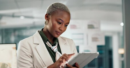 Poster - Business, black woman and typing on tablet in office at night for email feedback, project research and corporate deadline. Professional, finance employee and overtime on digital tech with planning