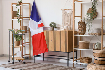 Wall Mural - Interior of light living room with French flags, commode and shelf units