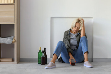 Wall Mural - Drunk mature woman at home. Concept of alcoholism