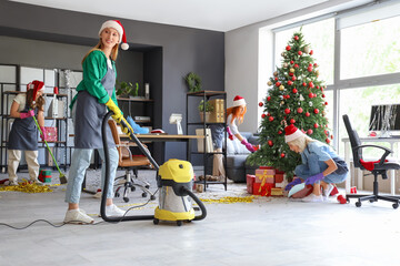 Poster - Female janitors cleaning office after Christmas party