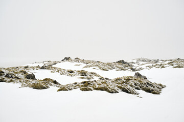 Sticker - Rocky terrain covered in ice during snowfall