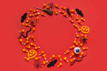 Sticker - Frame made of Halloween toys and candies on red background