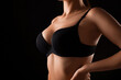 © Pixel-Shot - Young woman in bra on black background, closeup