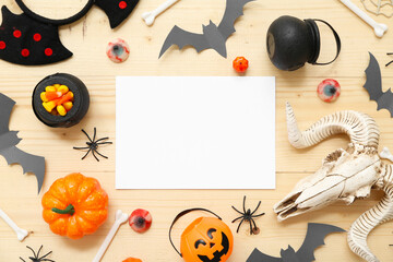 Sticker - Composition with blank card, different decorations and sweets for Halloween on wooden background