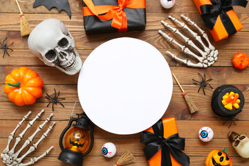 Sticker - Composition with blank card, different decorations and gifts for Halloween on wooden background