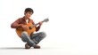 © BerkahStock - A young man playing an acoustic guitar, expressing joy and creativity.