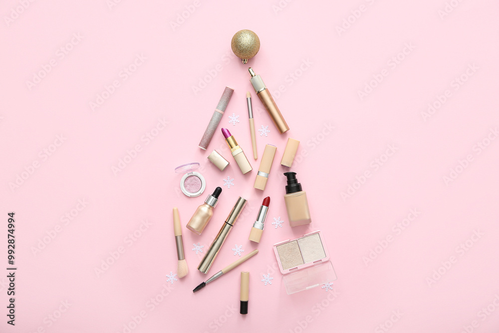 Christmas tree made of makeup products and decorations on pink background