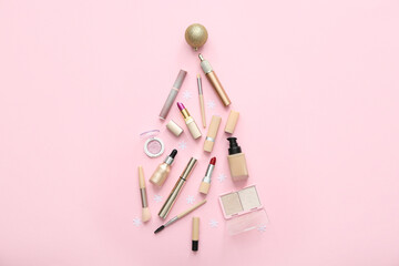 Wall Mural - Christmas tree made of makeup products and decorations on pink background