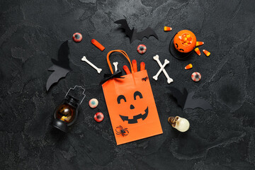 Wall Mural - Shopping bag with Halloween decorations, lanterns and candies on black background