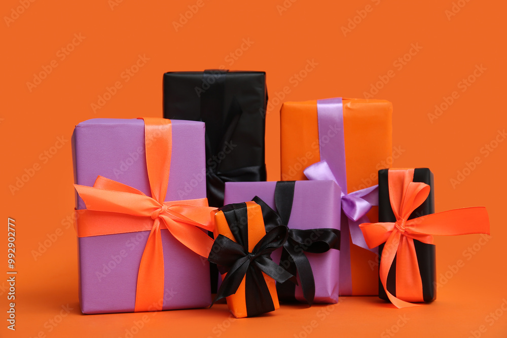 Different Halloween gift boxes on orange background