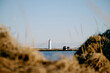 © Cavan Images - Lighthouse of settlement on seashore in sunlight