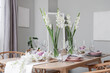 © Pixel-Shot - Beautiful table setting with white Gladiolus flowers and burning candles in room