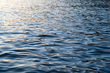 Water blue sea. Lake wave surface. Ocean texture abstract. Waves ripple reflection sunset.