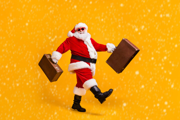 Poster - Full body profile side photo of white grey hair bearded santa claus go carry luggage x-mas christmas eve noel trip wear cap sunglass boots isolated yellow shine color background