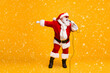© deagreez - Full body photo of crazy santa claus sing microphone song on christmas x-mas newyear disco wear sunglass headwear cap isolated over bright shine color background