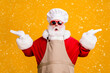 © deagreez - Photo of amazed santa claus with beard in chef cap hold hand compare x-mas christmas newyear magic cook meal discounts wear apron isolated bright shine color background
