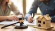 © Billy - Divorced couple signing property division papers with a gavel nearby