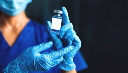 Doctor hands in blue gloves holding measles,coronavirus,covid vaccine