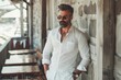 © Oleksandr - White Shirt Man: Elegant Businessman Leaning Against Cafe Wall with Sunglasses