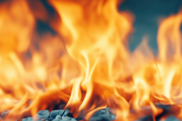 Close-up of bright orange flames with glowing embers and intense heat