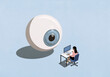 © fStop - Large blue eyeball watching businesswoman working at computer