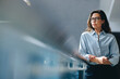 © Jacob Lund - Thoughtful business woman standing on a balcony, reflecting on her goals and vision for her company