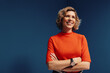 © Jacob Lund - Confident mature businesswoman in vibrant colorblocking portrait with a blue and orange monochromatic set