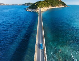 Aerial drone top view of blue car driving on bridge asphalt road above the sea or ocean water coast. Summer tourism travel and transportation landscape, trip, rock, cliff