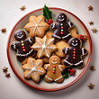 © Swen Weber - Assorted Christmas cookies, including gingerbread men, sugar cookies with festive icing, and star-shaped biscuits, arranged on a ceramic plate with a sprig of holly for decoration.